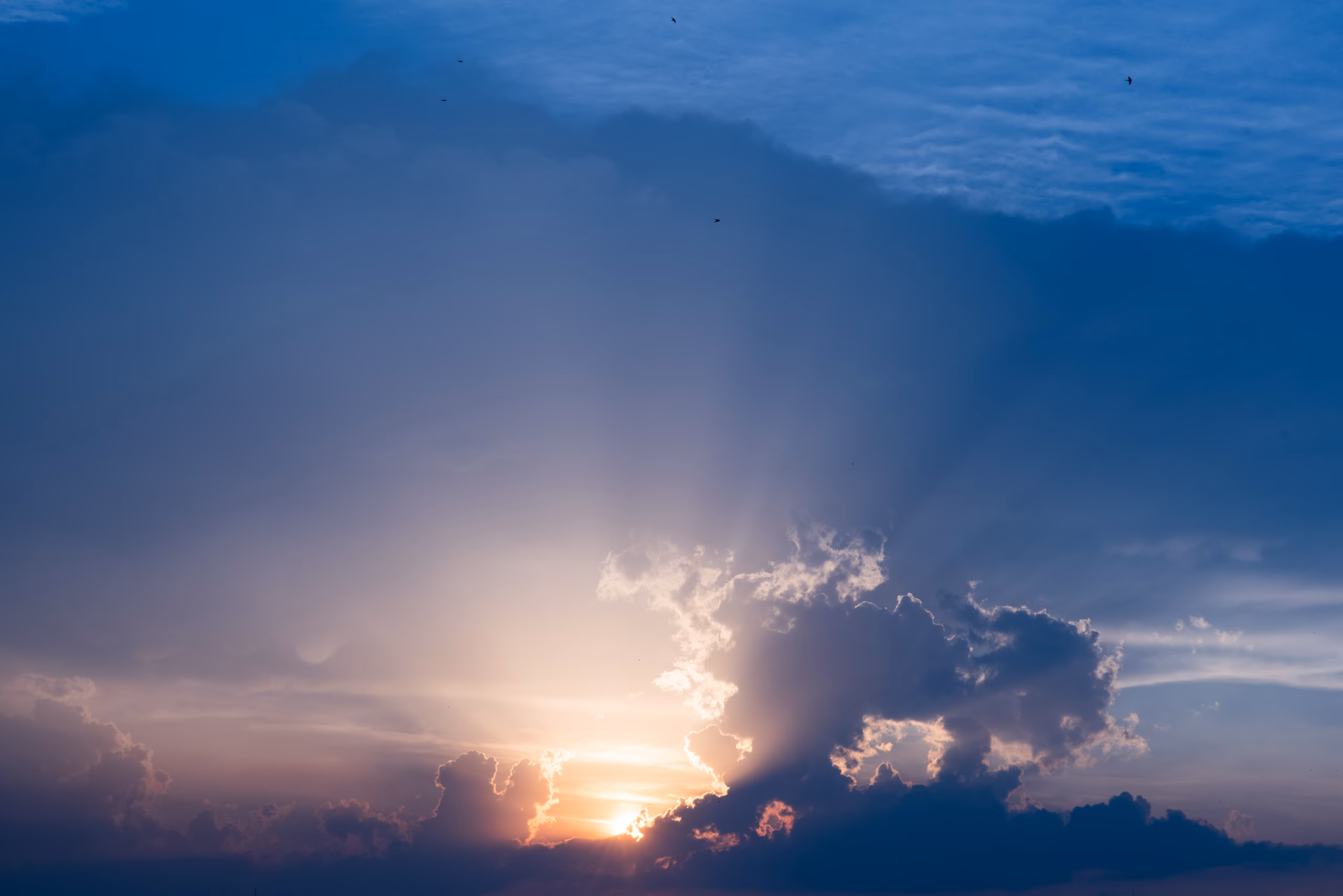 Sunset sky dramatic sunset clouds and sunset sunrays. Beautiful colorful dramatic sky with clouds at sunset or sunrise. Sun rays. Skyscape nature composition. Natural sky background.